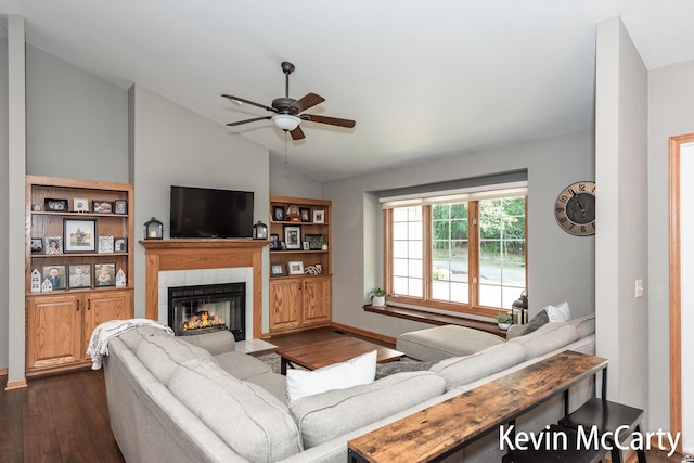530 Pine Haven Dr, Comstock Park, MI 49321 - living area with vaulted ceiling, dark wood finished floors, a ceiling fan, and a fireplace
