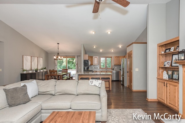 530 Pine Haven Dr, Comstock Park, MI 49321 - living area with dark wood-type flooring, ceiling fan, a chandelier, and high vaulted ceiling