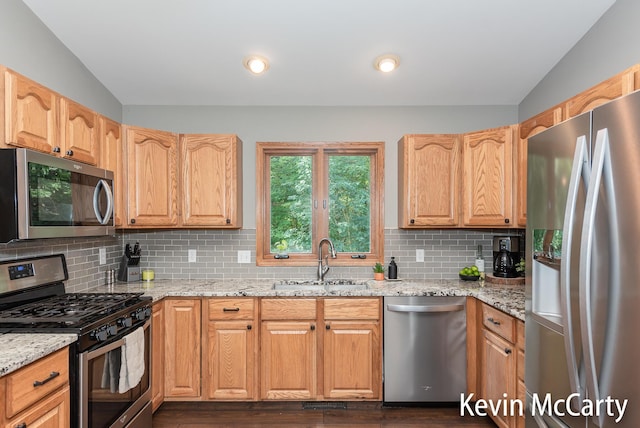 530 Pine Haven Dr, Comstock Park, MI 49321 - kitchen with appliances with stainless steel finishes, lofted ceiling, tasteful backsplash, light stone counters, and dark wood finished floors