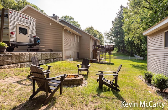 530 Pine Haven Dr, Comstock Park, MI 49321 - view of green lawn featuring a fire pit, stairs, and a deck