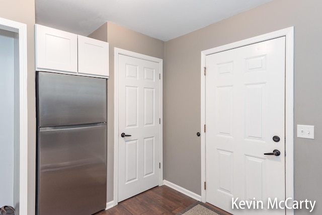 530 Pine Haven Dr, Comstock Park, MI 49321 - kitchen featuring stainless steel fridge, dark wood-style flooring, and white cabinetry