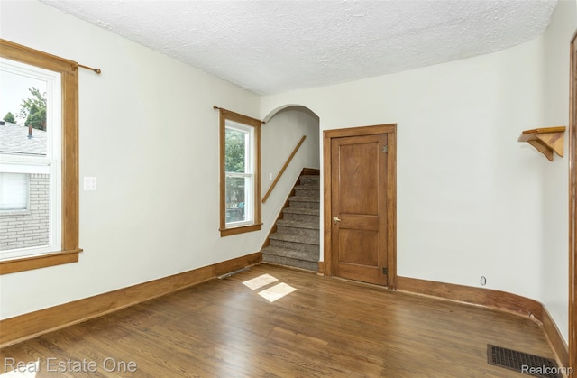 14711 Borgman St, Oak Park, MI 48237 - empty room featuring wood finished floors, a textured ceiling, and stairs