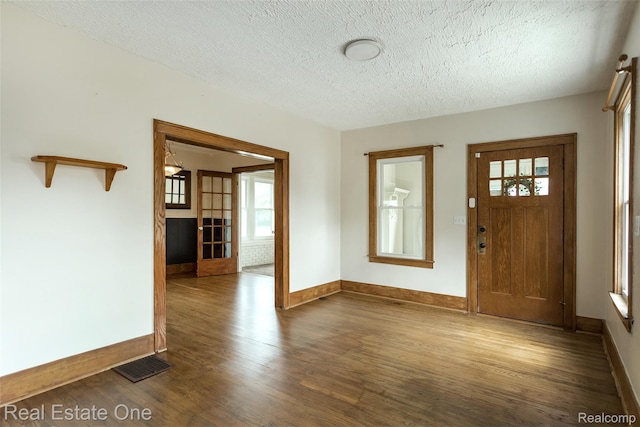 14711 Borgman St, Oak Park, MI 48237 - foyer entrance featuring wood finished floors, healthy amount of natural light, and a textured ceiling