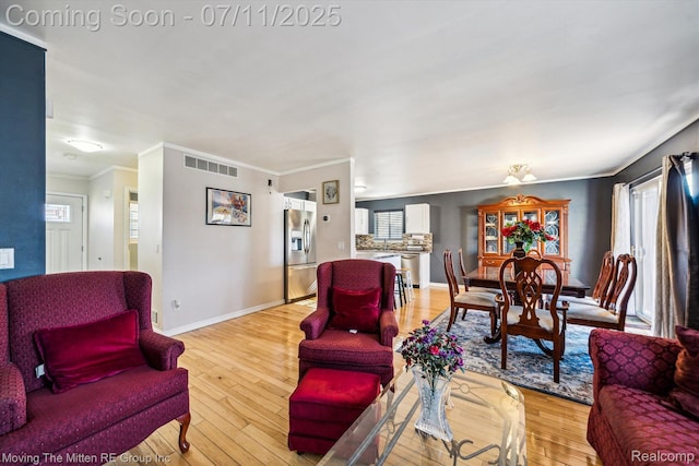 21203 Collingham Ave, Farmington Hills, MI 48336 - living room featuring ornamental molding and light wood-type flooring