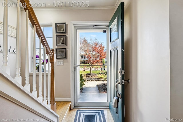 21203 Collingham Ave, Farmington Hills, MI 48336 - foyer with stairway, plenty of natural light, ornamental molding, and wood finished floors