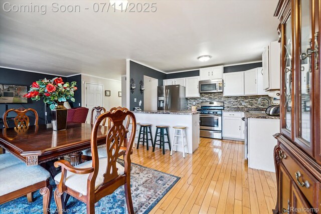 21203 Collingham Ave, Farmington Hills, MI 48336 - dining area featuring light wood finished floors and crown molding