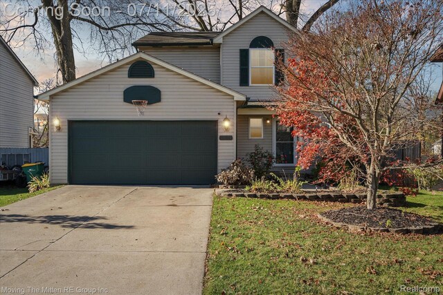 21203 Collingham Ave, Farmington Hills, MI 48336 - traditional home with driveway, an attached garage, and a front yard