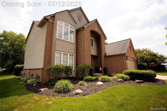 6020 Majestic Oaks Dr, Commerce Twp, MI 48382 - traditional-style home featuring brick siding, a front lawn, and an attached garage