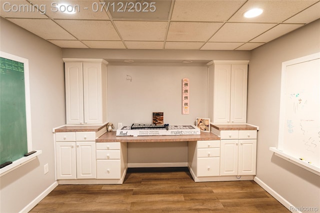 6020 Majestic Oaks Dr, Commerce Twp, MI 48382 - unfurnished office featuring built in study area, dark wood-style flooring, and a drop ceiling