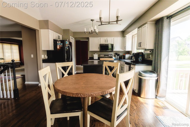 6020 Majestic Oaks Dr, Commerce Twp, MI 48382 - dining area with a chandelier and dark wood-type flooring