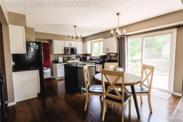 6020 Majestic Oaks Dr, Commerce Twp, MI 48382 - dining area with a chandelier and dark wood-style flooring