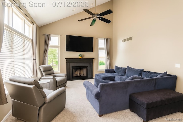 6020 Majestic Oaks Dr, Commerce Twp, MI 48382 - carpeted living area featuring high vaulted ceiling, a fireplace with flush hearth, and ceiling fan