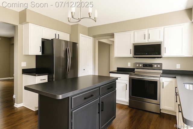 6020 Majestic Oaks Dr, Commerce Twp, MI 48382 - kitchen with appliances with stainless steel finishes, dark countertops, and white cabinets