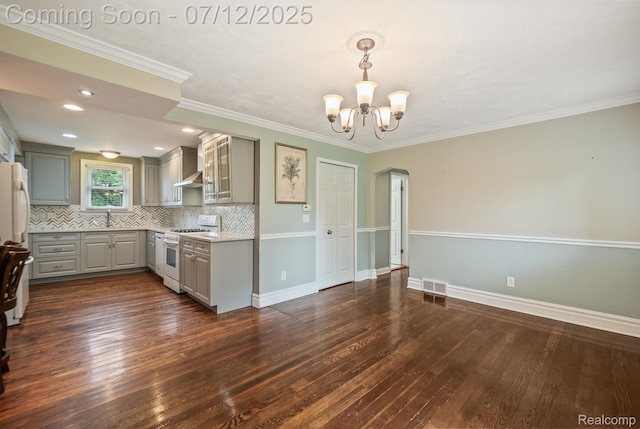3811 Benstein Rd, Commerce Twp, MI 48382 - kitchen with white gas range, gray cabinets, wall chimney range hood, dark wood-type flooring, and backsplash