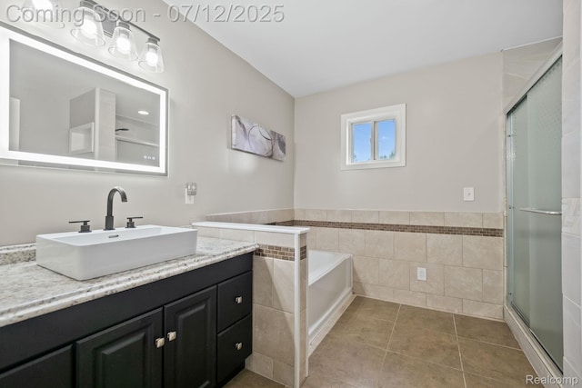 3811 Benstein Rd, Commerce Twp, MI 48382 - bathroom with vanity, tile patterned flooring, a garden tub, a stall shower, and tile walls