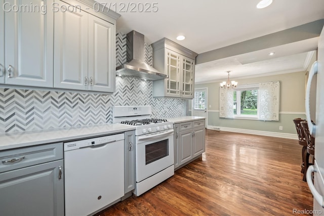 3811 Benstein Rd, Commerce Twp, MI 48382 - kitchen featuring white appliances, wall chimney range hood, crown molding, a chandelier, and gray cabinetry