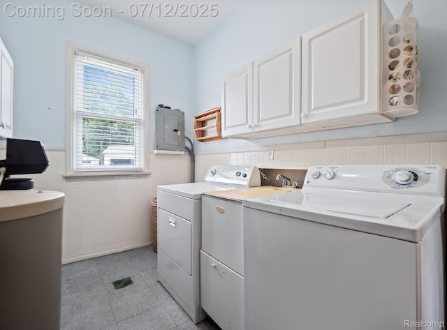 3811 Benstein Rd, Commerce Twp, MI 48382 - washroom featuring washer and dryer, electric panel, tile walls, cabinet space, and a wainscoted wall