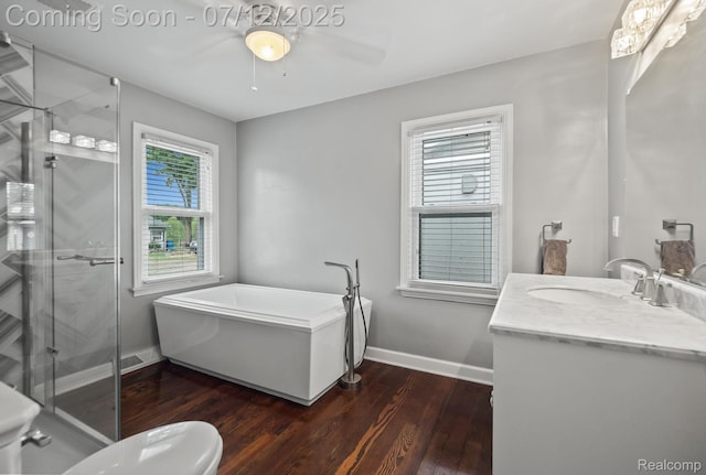 3811 Benstein Rd, Commerce Twp, MI 48382 - full bath with vanity, wood finished floors, a ceiling fan, a freestanding bath, and a shower stall