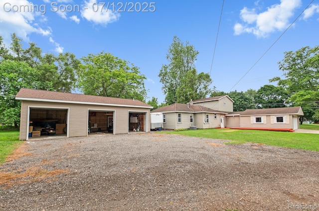 3811 Benstein Rd, Commerce Twp, MI 48382 - view of front of home with an outbuilding, a detached garage, and a front lawn