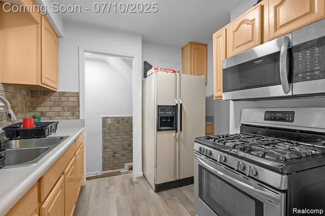 9099 NW Stout St NW, Detroit, MI 48228 - kitchen featuring stainless steel appliances and light brown cabinetry