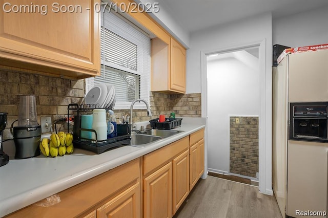 9099 NW Stout St NW, Detroit, MI 48228 - kitchen with white refrigerator with ice dispenser, light wood-style floors, light countertops, backsplash, and light brown cabinetry