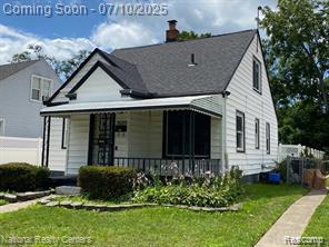 9099 NW Stout St NW, Detroit, MI 48228 - view of front facade featuring a front lawn, a chimney, and covered porch
