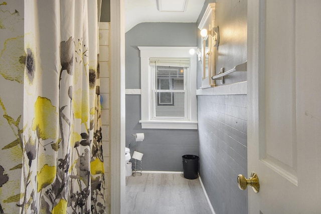 728 Fifth St, Jackson, MI 49203 - bathroom with tile walls, wood finished floors, and a shower with shower curtain