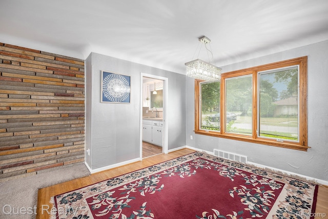 31618 Winchester Ave, Warren, MI 48092 - unfurnished dining area with a chandelier and light wood-style flooring