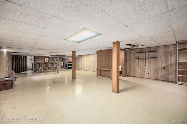 31618 Winchester Ave, Warren, MI 48092 - finished basement with wood walls, a paneled ceiling, a dry bar, and tile patterned floors