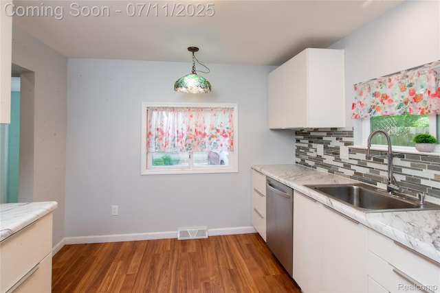 3110 Brisbane St, Walled Lake, MI 48390 - kitchen featuring dishwasher, light wood finished floors, white cabinetry, decorative backsplash, and light countertops