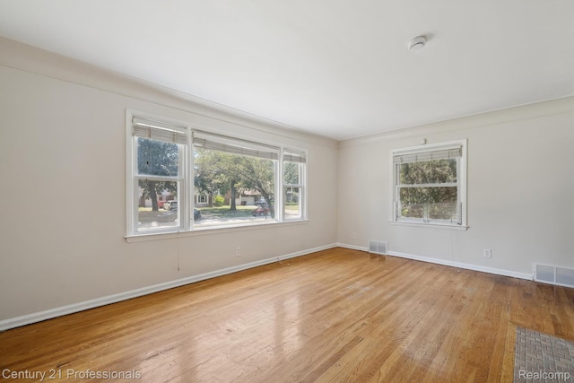18140 Westover Ave, Southfield, MI 48075 - empty room with wood finished floors, healthy amount of natural light, and a smoke detector