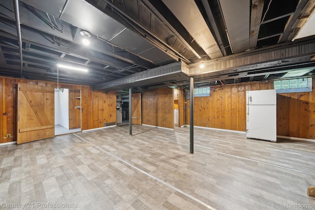 18140 Westover Ave, Southfield, MI 48075 - basement with freestanding refrigerator, wooden walls, wood finished floors, and plenty of natural light