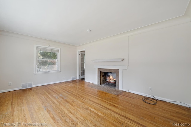18140 Westover Ave, Southfield, MI 48075 - unfurnished living room featuring a fireplace with flush hearth and wood finished floors