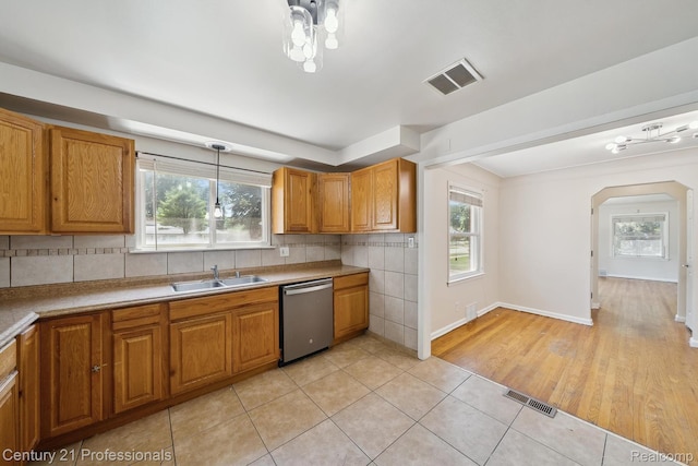18140 Westover Ave, Southfield, MI 48075 - kitchen with dishwasher, healthy amount of natural light, light tile patterned floors, and brown cabinetry
