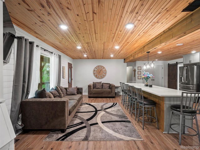 3365 Howland Rd, Almont, MI 48003 - living room with a barn door, light wood-type flooring, recessed lighting, and wooden ceiling