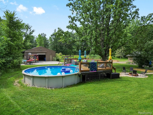 3365 Howland Rd, Almont, MI 48003 - swimming pool with a lawn, an outdoor structure, view of scattered trees, and a deck