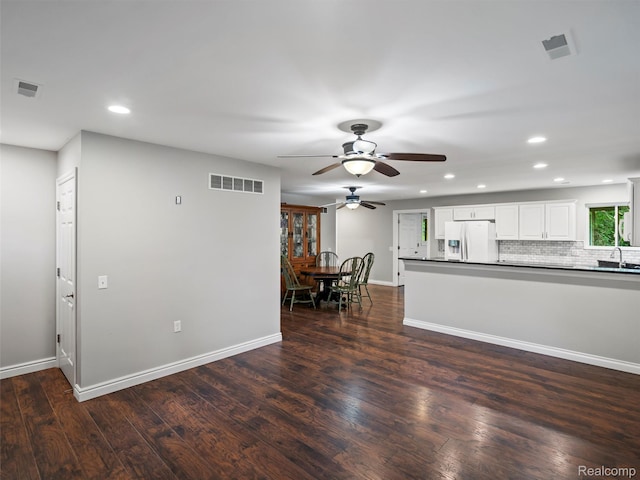 3365 Howland Rd, Almont, MI 48003 - kitchen with a ceiling fan, white fridge with ice dispenser, dark countertops, recessed lighting, and dark wood finished floors