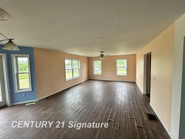 7265 Deweigan Ln, Mount Pleasant, MI 48858 - spare room with dark wood-style flooring, a ceiling fan, and a textured ceiling