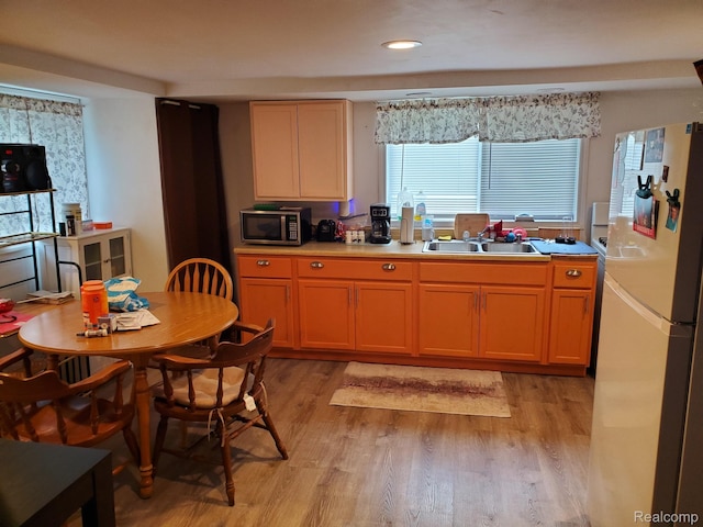 244 S Sherman St, Vassar, MI 48768 - kitchen featuring freestanding refrigerator, stainless steel microwave, light wood-style floors, light countertops, and recessed lighting