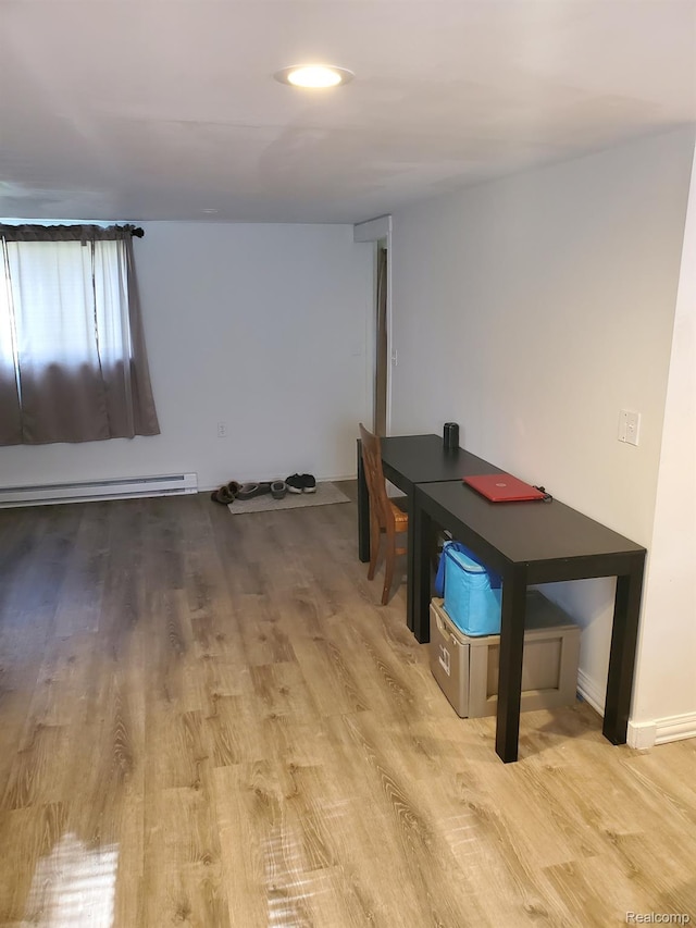 244 S Sherman St, Vassar, MI 48768 - unfurnished dining area with wood finished floors and baseboard heating
