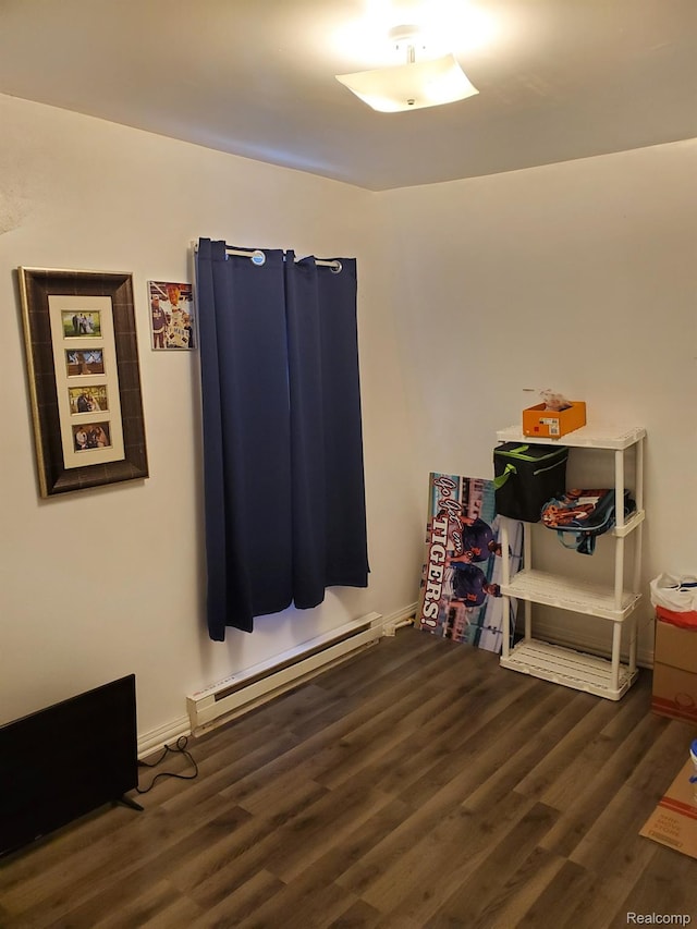 244 S Sherman St, Vassar, MI 48768 - interior space with a baseboard radiator and wood finished floors