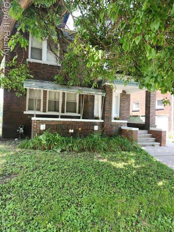 1950 Lawrence St, Detroit, MI 48206 - view of front of home with brick siding and a porch