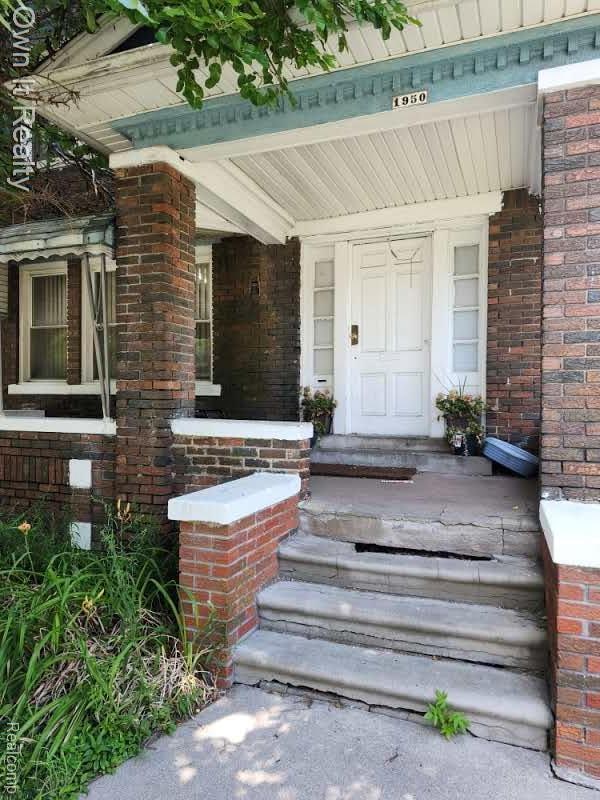 1950 Lawrence St, Detroit, MI 48206 - doorway to property with brick siding and covered porch