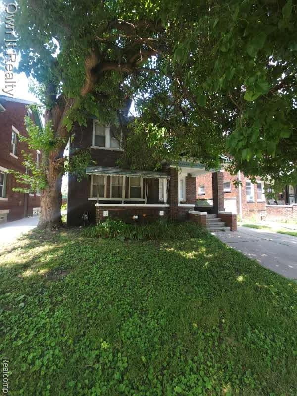 1950 Lawrence St, Detroit, MI 48206 - obstructed view of property featuring a front yard