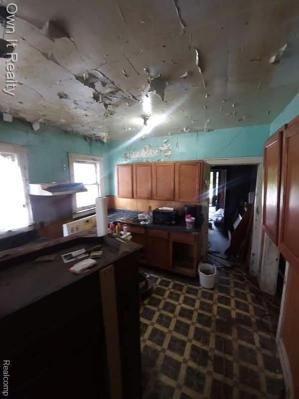 1950 Lawrence St, Detroit, MI 48206 - kitchen featuring brown cabinetry and dark countertops