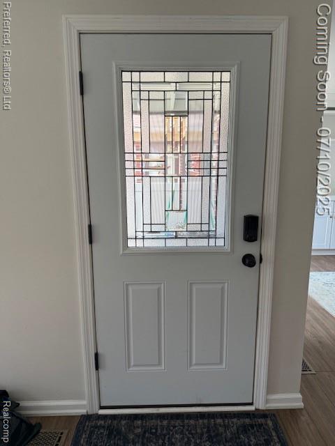 40219 Newport Dr, Plymouth, MI 48170 - doorway to outside featuring baseboards and wood finished floors