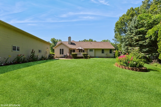 4175 Schmuhl Rd, Coloma, MI 49038 - rear view of property featuring a lawn, a wooden deck, and a chimney