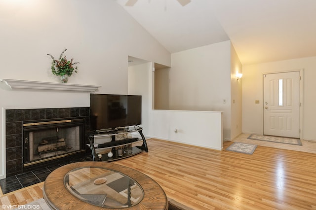 4175 Schmuhl Rd, Coloma, MI 49038 - living room featuring lofted ceiling, wood finished floors, a ceiling fan, and a fireplace