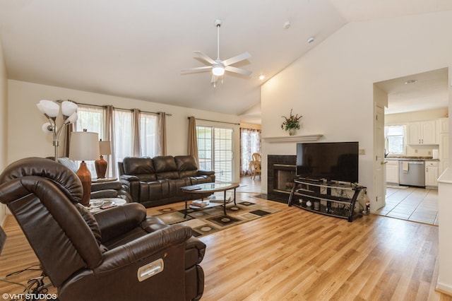 4175 Schmuhl Rd, Coloma, MI 49038 - living room with a ceiling fan, a fireplace, light wood finished floors, and high vaulted ceiling