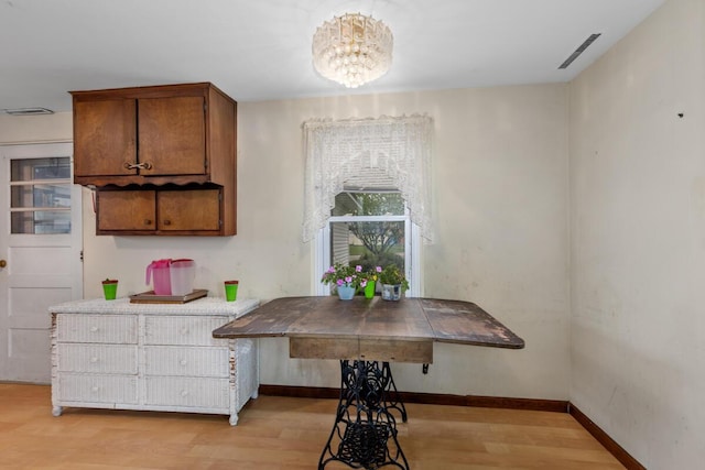 3116 E Apple Ave, Muskegon, MI 49442 - kitchen featuring brown cabinets, a chandelier, and light wood-style flooring